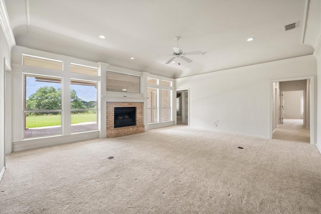 128 Rim Rock Road Aledo, TX 76008 - Photo 10 of 40 Living room with a wall of windows.