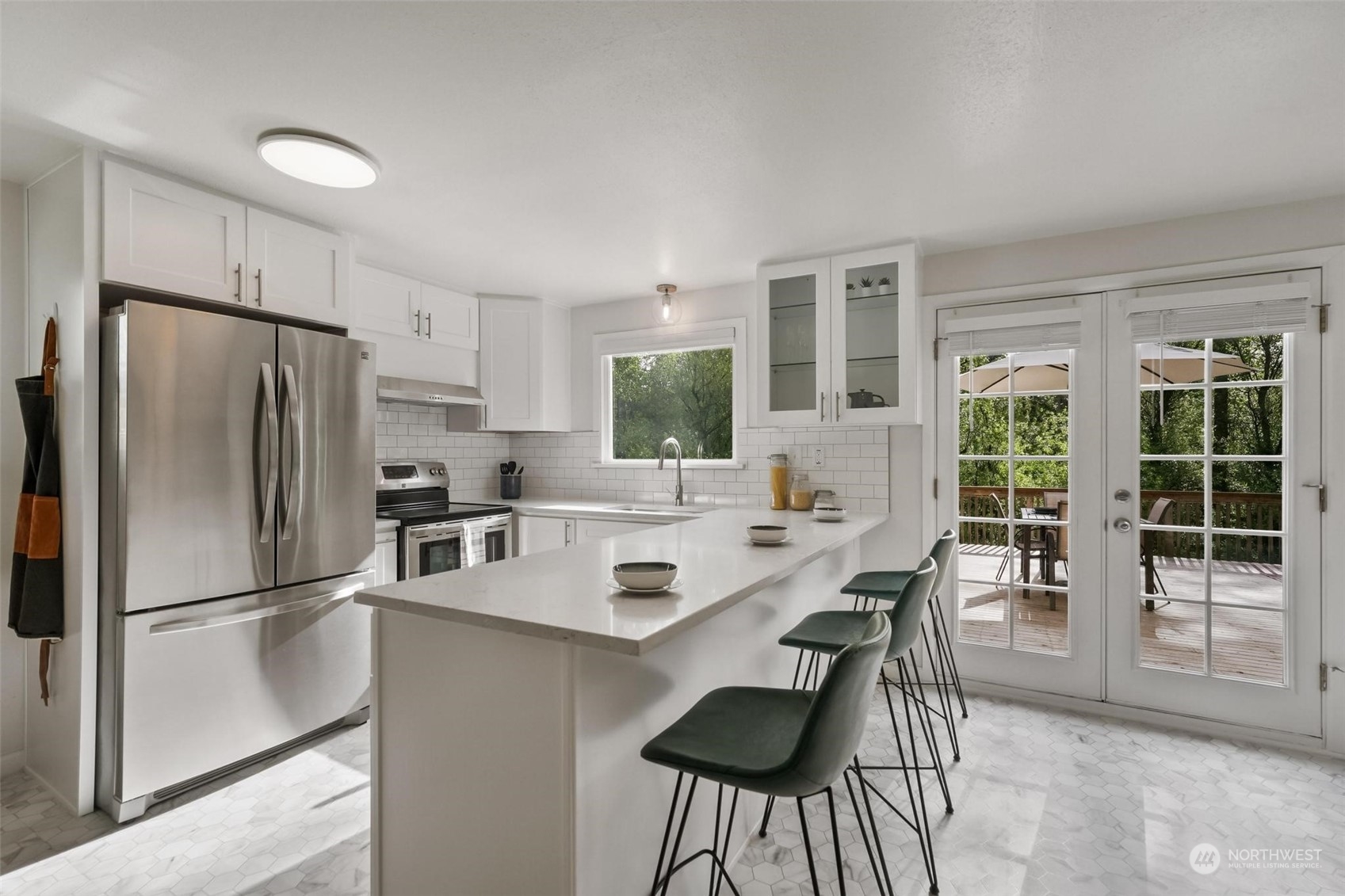2232 South 330th Street Federal Way, WA 98003 - Photo 12 of 39 a kitchen with stainless steel appliances a refrigerator a stove a dining table and chairs