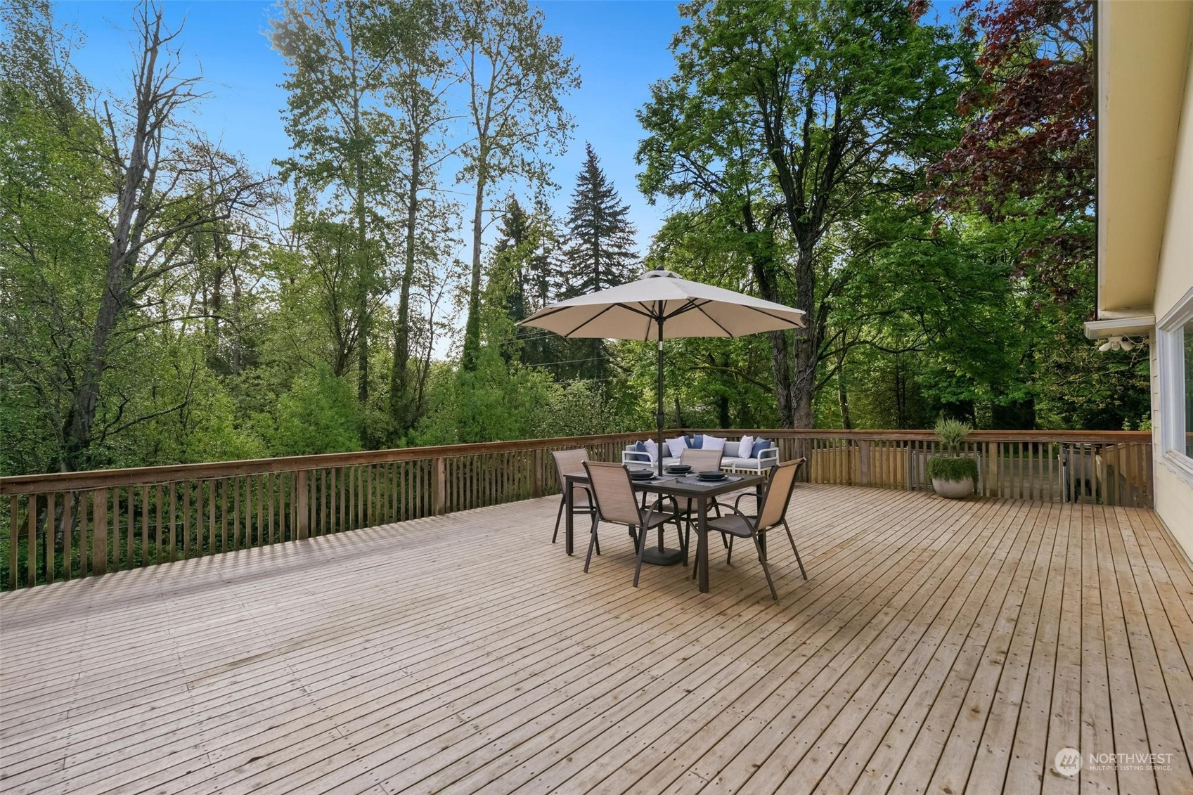 2232 South 330th Street Federal Way, WA 98003 - Photo 14 of 39 a view of a roof deck with table and chairs under an umbrella with wooden floor and fence