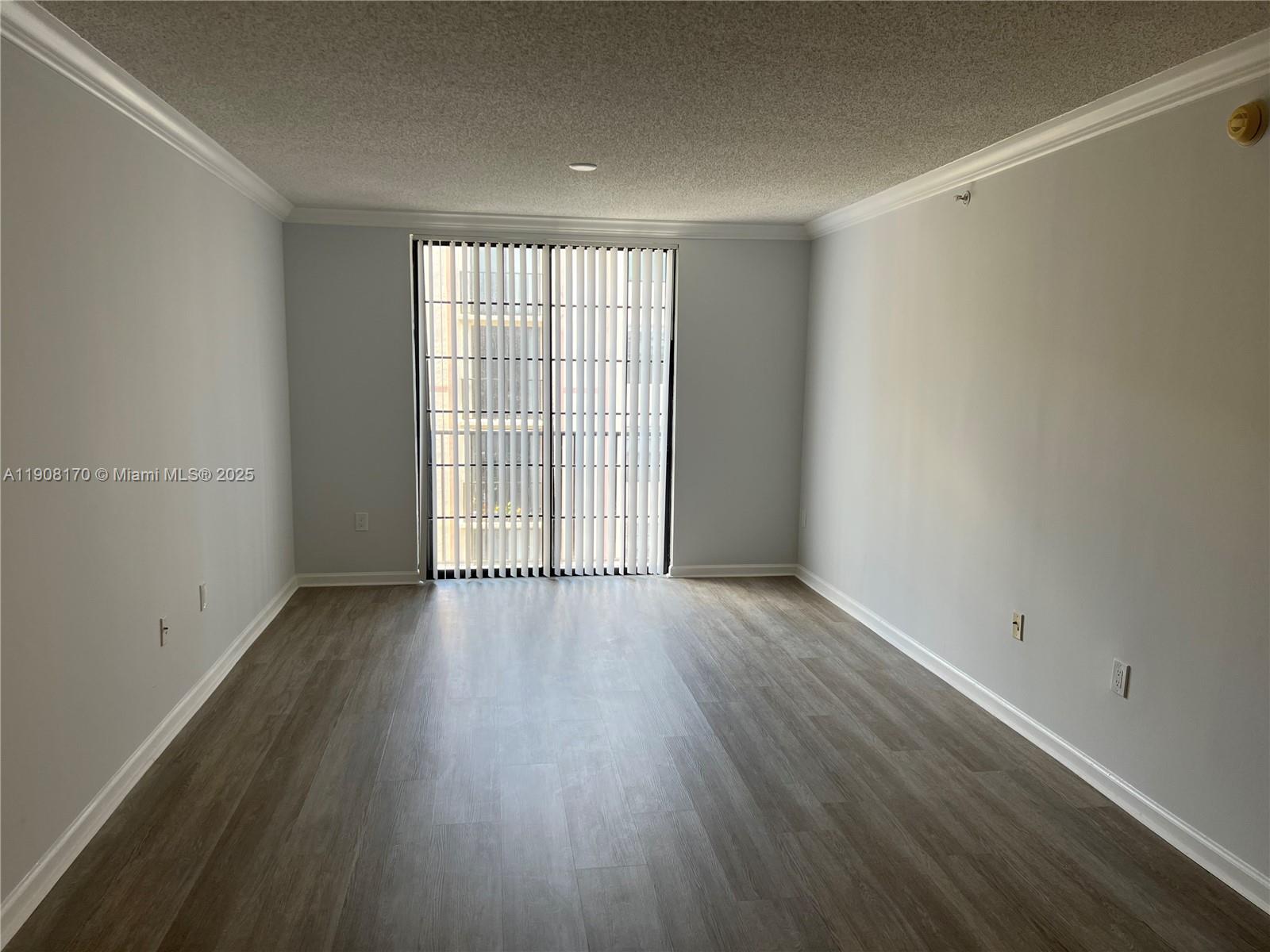 1919 Van Buren Street, Unit 720A Hollywood, FL 33020 - Photo 6 of 22 wooden floor in an empty room with a window