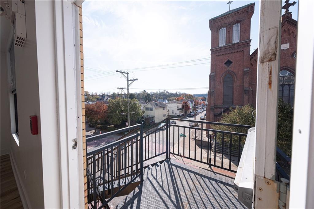 232 3rd Avenue, Unit 3 Carnegie, PA 15106 - Photo 16 of 21 a view of a balcony with a floor to ceiling window and wooden fence