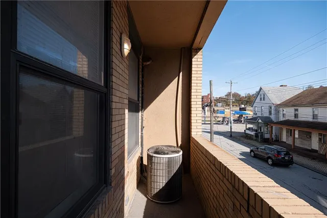a balcony with view of an outdoor space