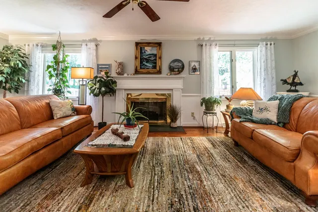 a living room with furniture and a fireplace