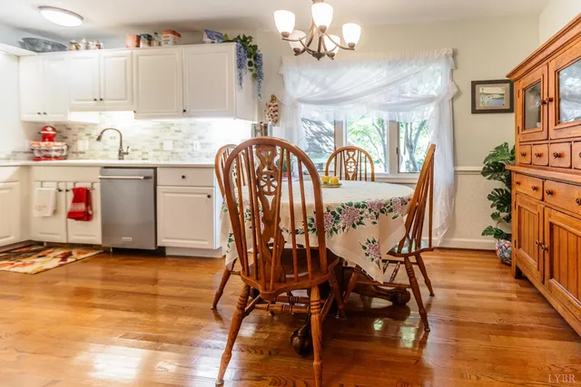 a kitchen with a table chairs refrigerator and cabinets