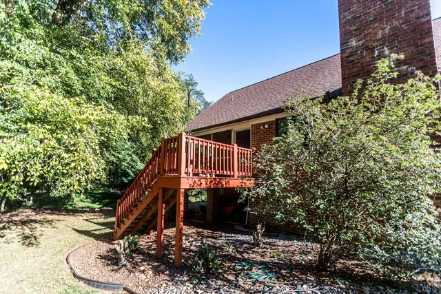 a balcony with wooden floor and fence