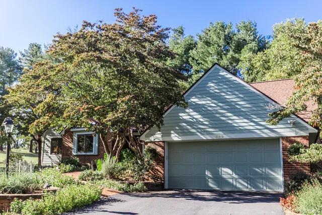 a small house with a tree in the background