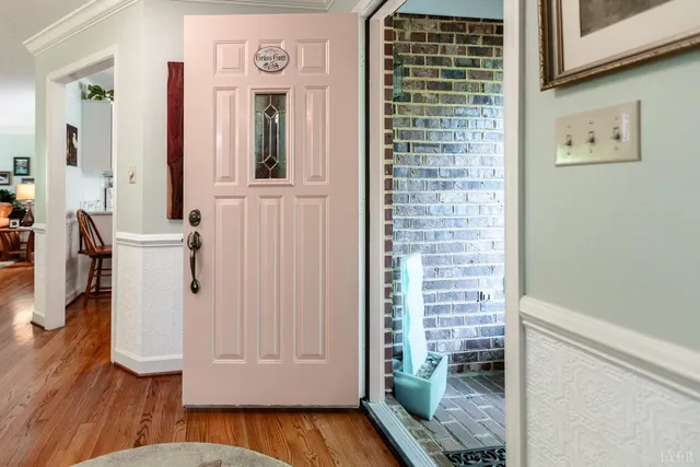 a view of a hallway with wooden floor and entryway