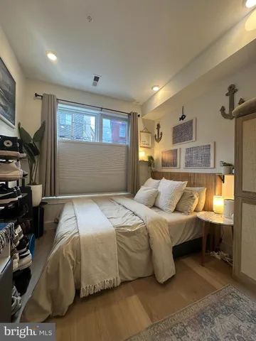 a bedroom with a bed and a night stand