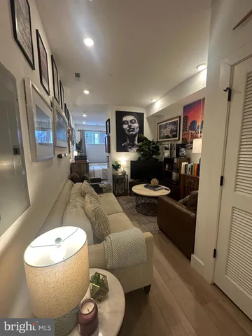 a living room with furniture and a wooden floor