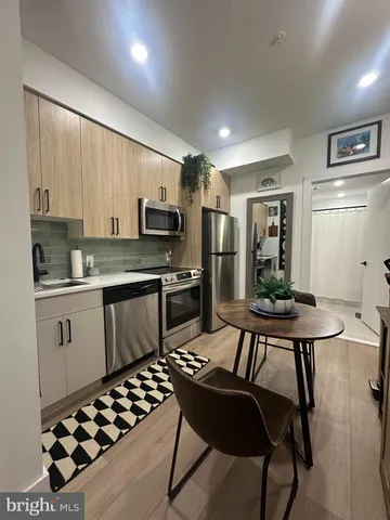 a kitchen with a table chairs sink and cabinets