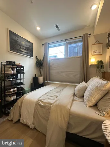 a bedroom with a bed and a tv