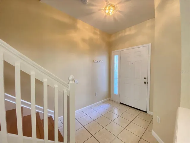 a view of a hallway with a chandelier fan