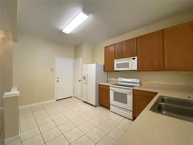 a kitchen with stainless steel appliances granite countertop a sink and cabinets