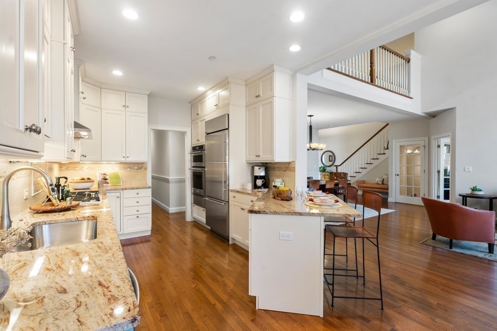25 South Cottage Road, Unit 25 Belmont, MA 02478 - Photo 11 of 29 a kitchen with a sink stove and wooden cabinets