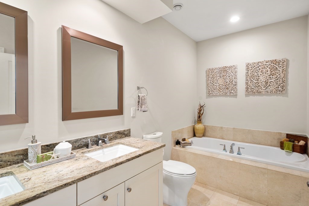 25 South Cottage Road, Unit 25 Belmont, MA 02478 - Photo 15 of 29 a bathroom with a granite countertop sink mirror vanity bathtub and a toilet