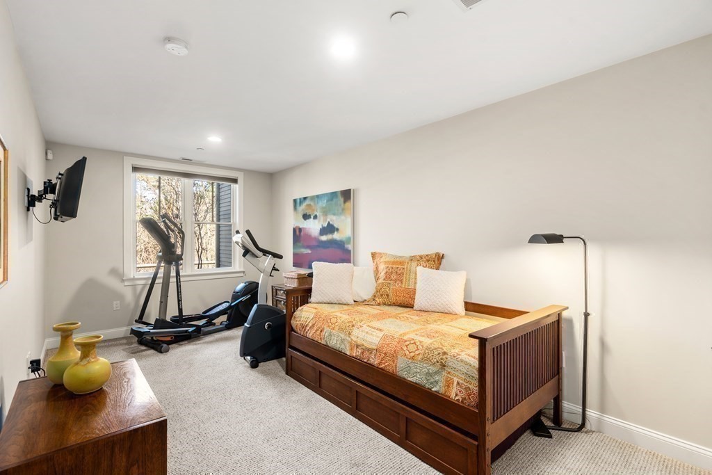 25 South Cottage Road, Unit 25 Belmont, MA 02478 - Photo 25 of 29 a bedroom with a bed a desk and chair