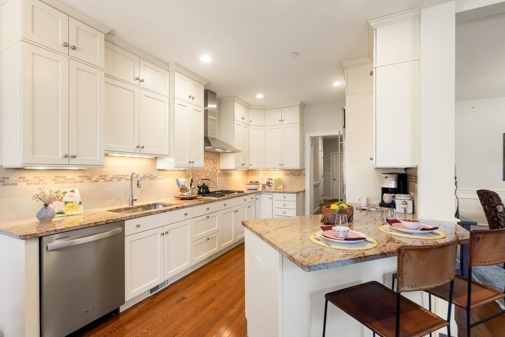 25 South Cottage Road, Unit 25 Belmont, MA 02478 - Photo 8 of 29 a kitchen with a sink white cabinets and chairs