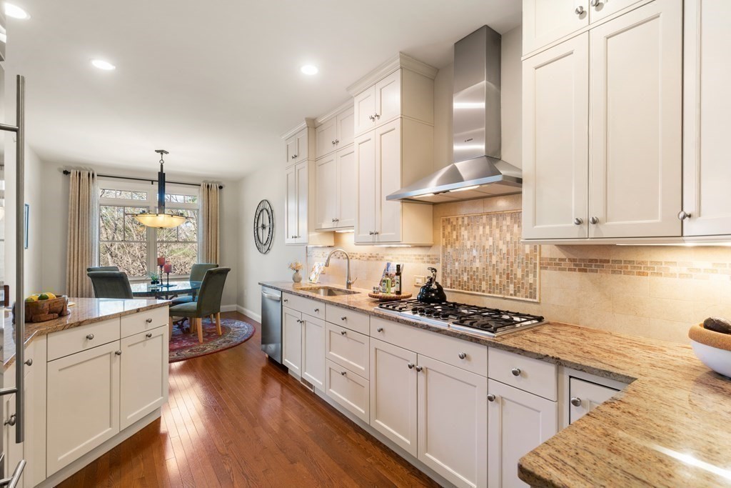 25 South Cottage Road, Unit 25 Belmont, MA 02478 - Photo 9 of 29 a kitchen with stainless steel appliances a sink stove and cabinets