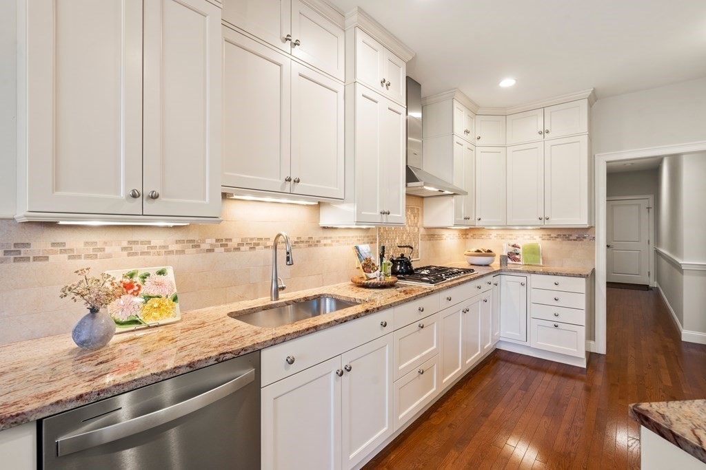 25 South Cottage Road, Unit 25 Belmont, MA 02478 - Photo 10 of 29 a kitchen with granite countertop white cabinets and white appliances