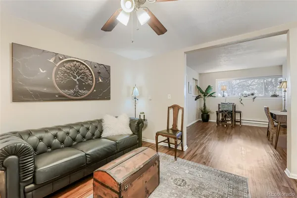 a living room with furniture and wooden floor