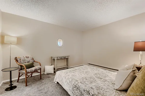 a bedroom with a bed and chair