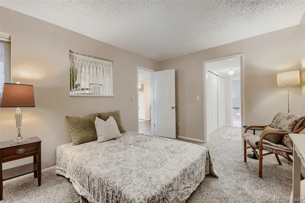 a bedroom with a bed and lamp