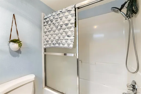 a bathroom with a shower and a toilet