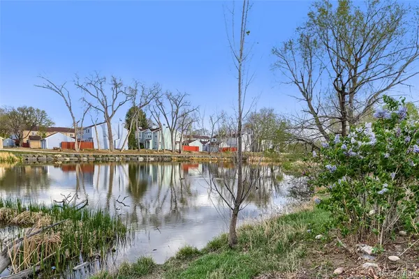 a view of a lake with houses in the back
