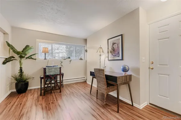 a workspace with furniture window and wooden floor