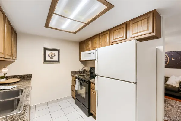 a kitchen with stainless steel appliances a refrigerator sink and stove