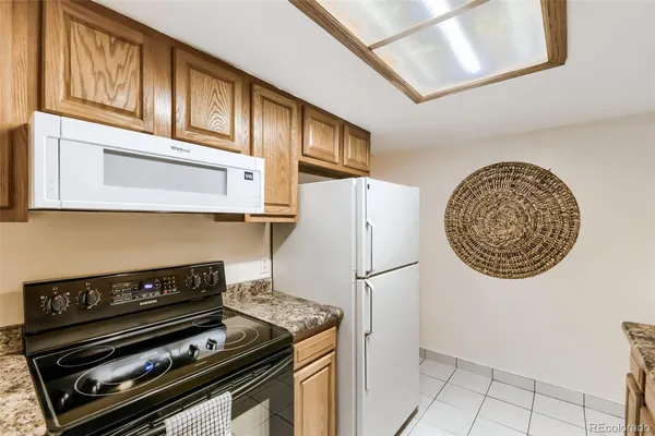 a stove top oven sitting inside of a kitchen