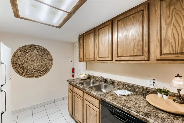 a bathroom with a granite countertop sink a mirror and a shower