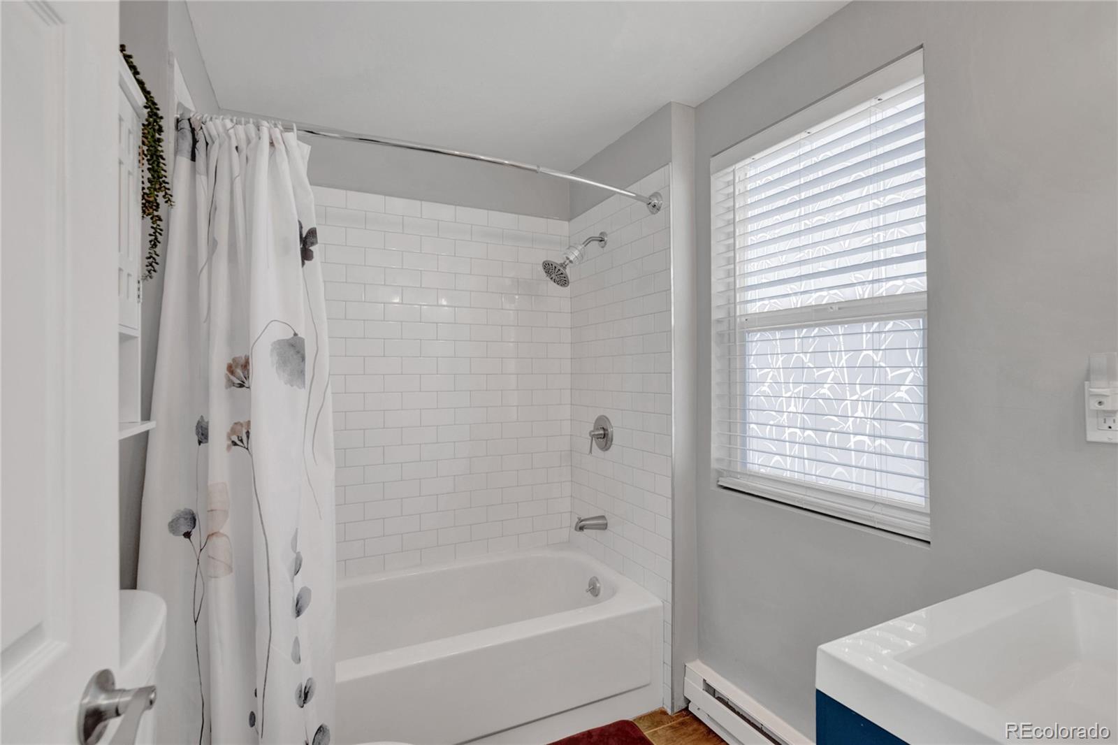 6949 Debutts Road Fort Garland, CO 81133 - Photo 20 of 48 a bathroom with a bathtub a shower and a window