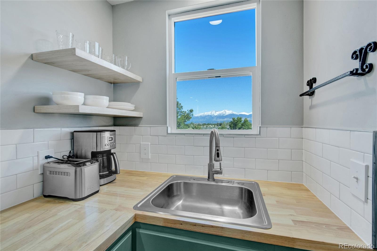 6949 Debutts Road Fort Garland, CO 81133 - Photo 40 of 48 a kitchen with stainless steel appliances a sink and a wooden floor