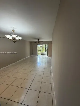 a view of an empty room with a chandelier