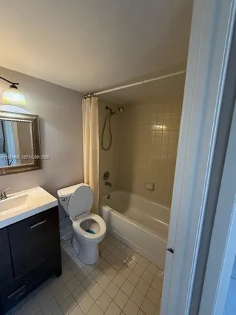a bathroom with a granite countertop toilet a sink and a mirror