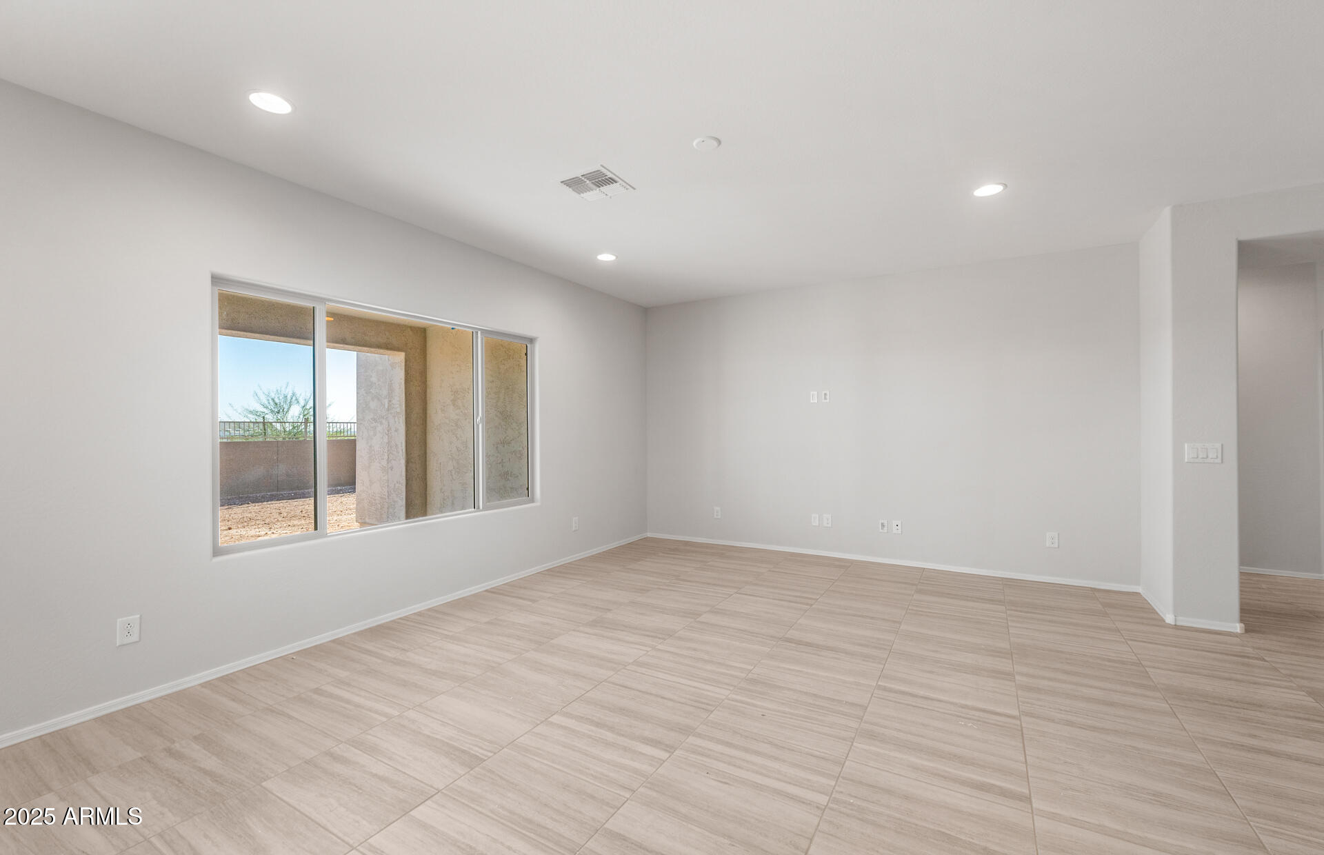 6795 West Ripken Way Florence, AZ 85132 - Photo 14 of 35 an empty room with wooden floor and windows