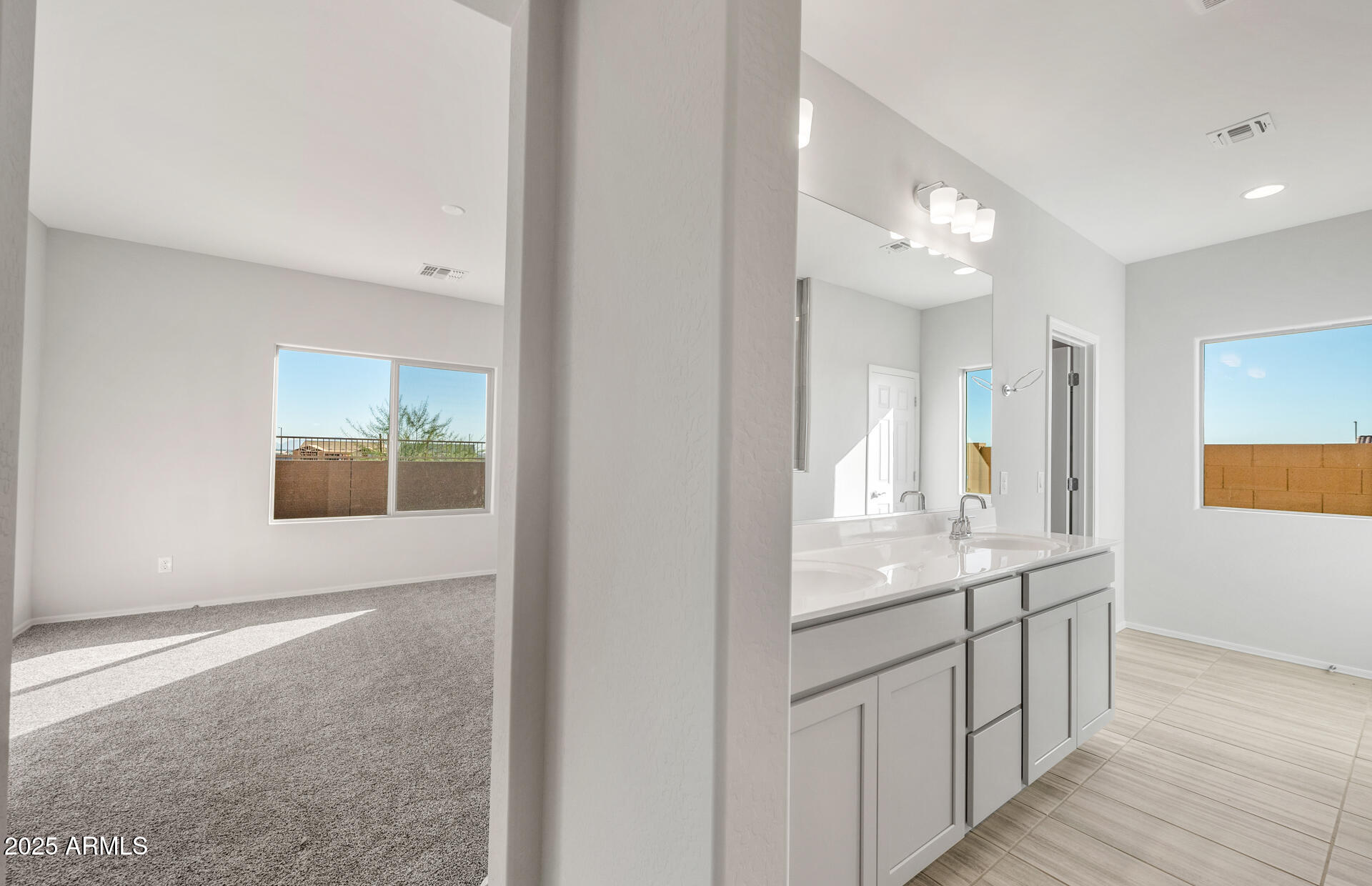 6795 West Ripken Way Florence, AZ 85132 - Photo 27 of 35 a bathroom with a double vanity sink and a mirror