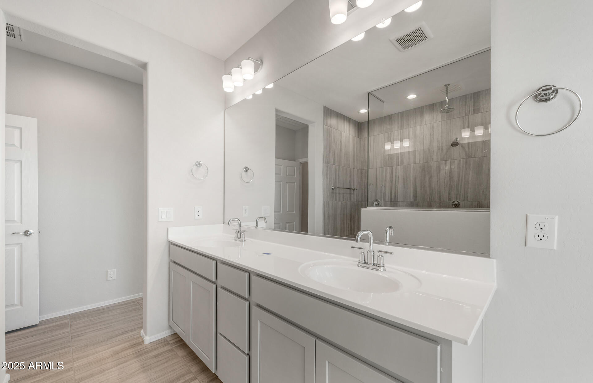 6795 West Ripken Way Florence, AZ 85132 - Photo 30 of 35 a bathroom with a sink double vanity and a mirror