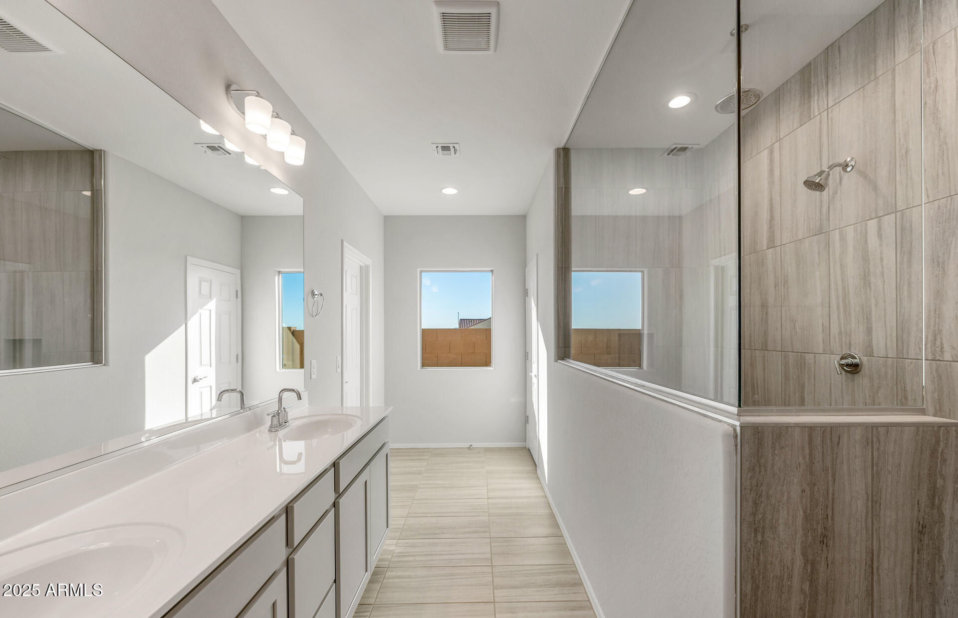 6795 West Ripken Way Florence, AZ 85132 - Photo 32 of 35 a bathroom with a double vanity sink and mirror