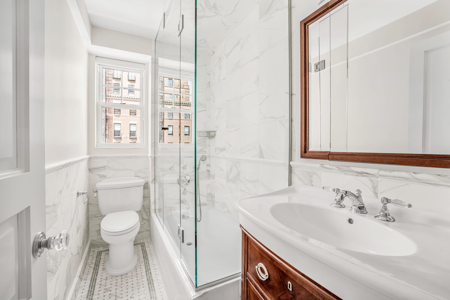 785 Park Avenue, Unit 13DE Manhattan, NY 10021 - Photo 12 of 15 a bathroom with a sink a toilet and shower