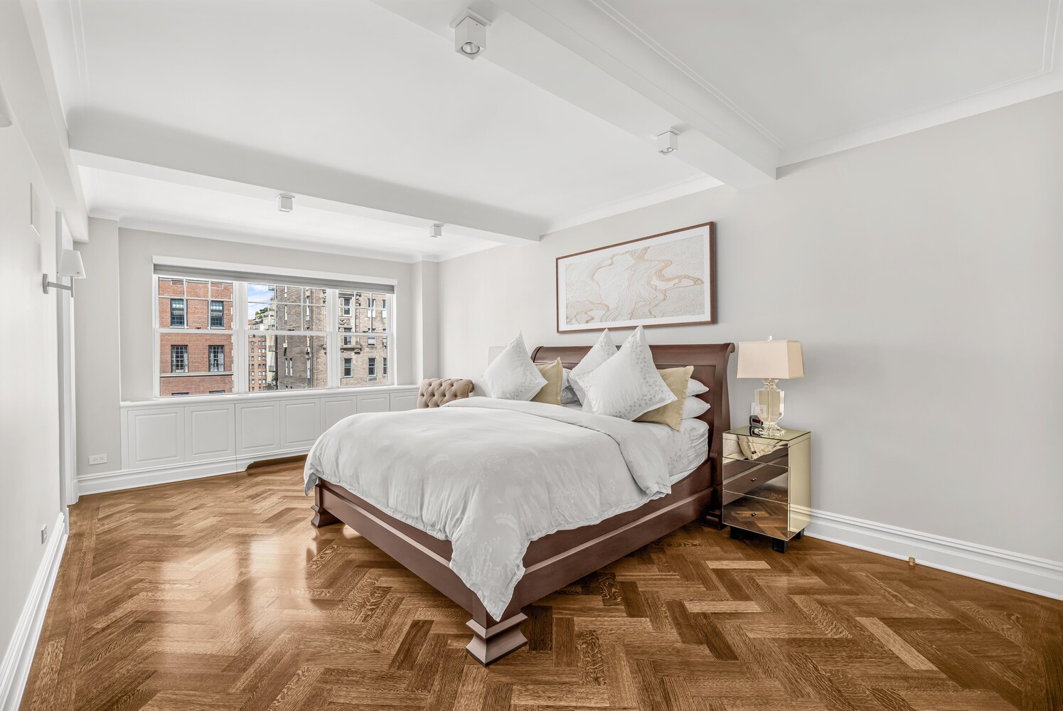 785 Park Avenue, Unit 13DE Manhattan, NY 10021 - Photo 7 of 15 a bed sitting in a spacious bedroom next to a window and a chair