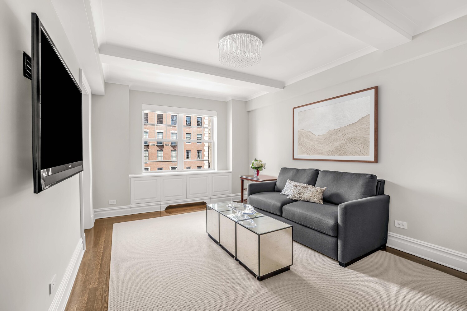 785 Park Avenue, Unit 13DE Manhattan, NY 10021 - Photo 9 of 15 a living room with furniture and a flat screen tv