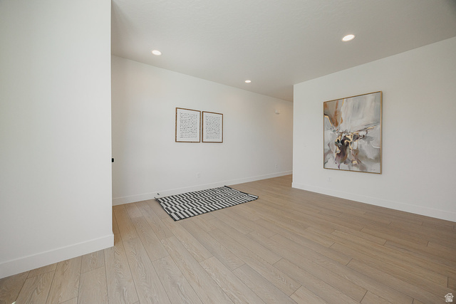 5902 Canyon Rim Road, Unit 620 Lehi, UT 84048 - Photo 71 of 78 Open room featuring light wood-finish flooring, white walls, recessed ceiling lighting, and crisp white baseboards