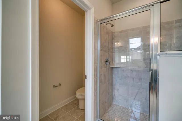 a bathroom with a glass shower door