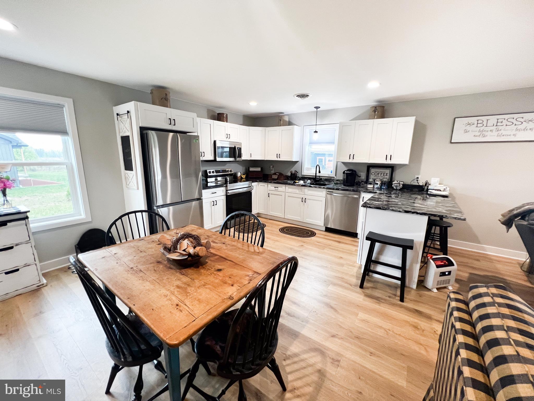 90 Tilbury Lane Reedsville, PA 17084 - Photo 13 of 28 a kitchen with stainless steel appliances kitchen island granite countertop a dining table chairs and refrigerator