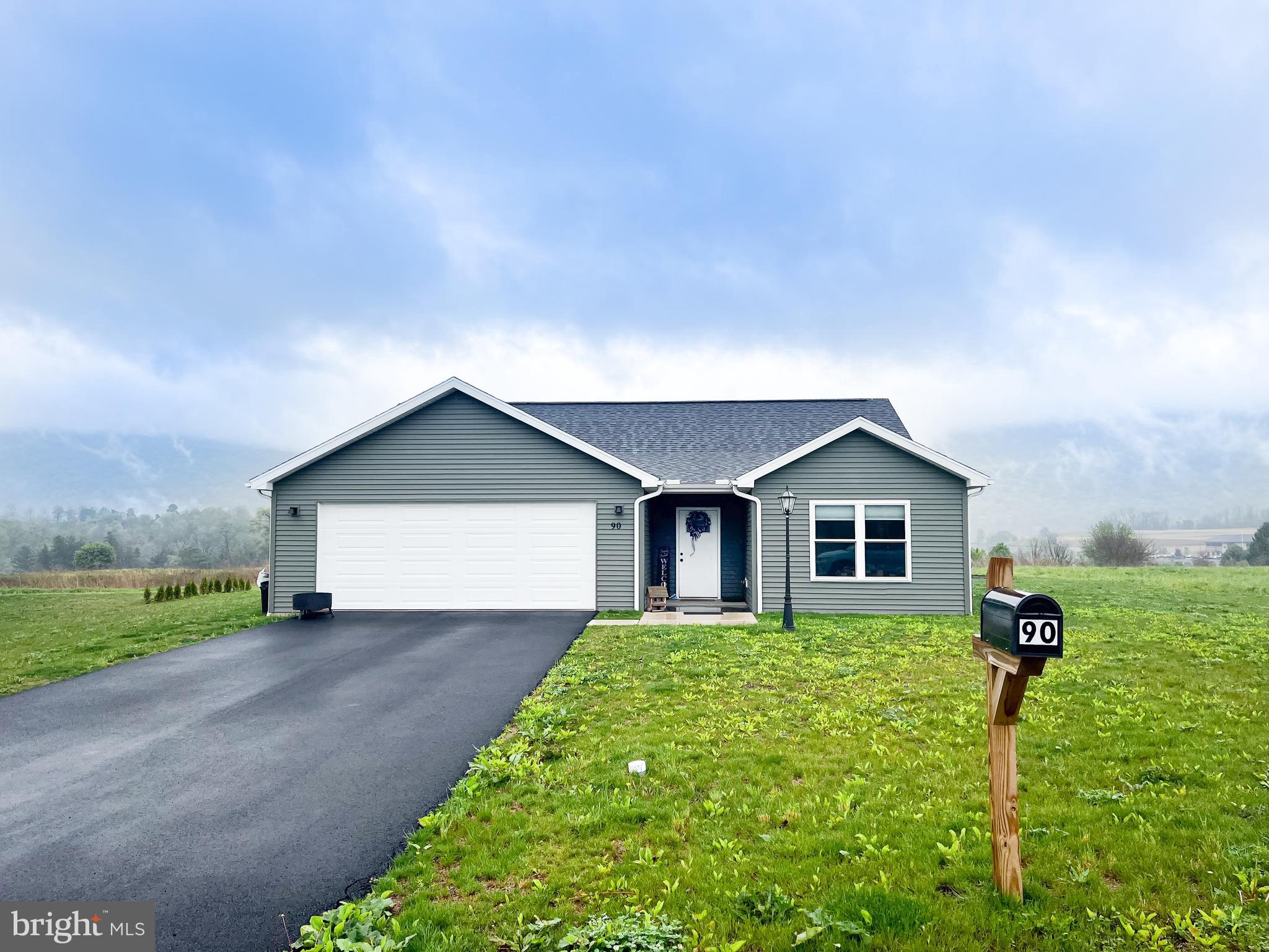 90 Tilbury Lane Reedsville, PA 17084 - Photo 2 of 28 a front view of a house with a yard and garage
