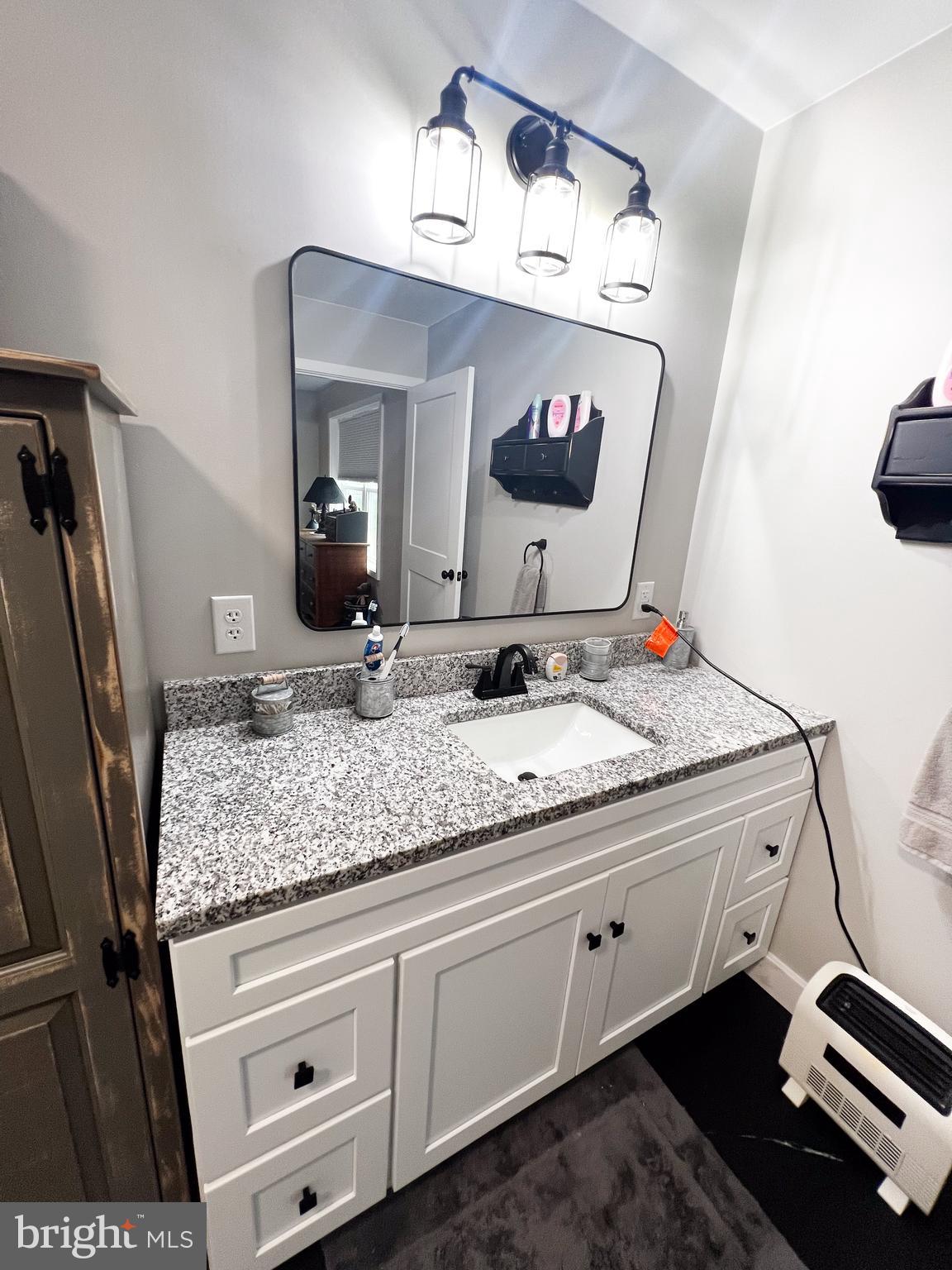 90 Tilbury Lane Reedsville, PA 17084 - Photo 27 of 28 a bathroom with a granite countertop sink and a mirror