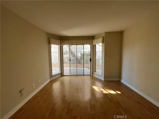 a view of an empty room with glass door