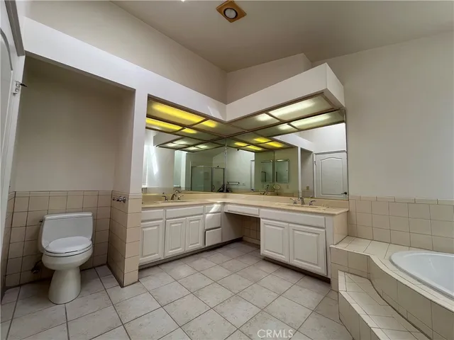 a bathroom with a granite countertop toilet a sink and bathtub